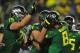EUGENE, OR. - SEPTEMBER 28: Quarterback Marcus Mariota #8 of the Oregon Ducks celebrates with the teammates including offensive linesman Jake Fisher #75 and offensive linesman Tyler Johnstone #64 of the Oregon Ducks after scoring a touchdown during the second quarter of the game against the California Golden Bears at Autzen Stadium on September 28, 2013 in Eugene, Oregon. (Photo by Steve Dykes/Getty Images)