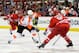 RALEIGH, NC - OCTOBER 06: Claude Giroux #28 of the Philadelphia Flyers moves the puck up the ice against Ron Hainsey #65 of the Carolina Hurricanes during play at PNC Arena on October 6, 2013 in Raleigh, North Carolina. The Hurricanes won 2-1. (Photo by Grant Halverson/Getty Images)