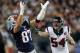 Jan 13, 2013; Foxboro, Massachusetts, USA; New England Patriots tight end Rob Gronkowski (87) prepares to catch the ball while being defended by Houston Texans line backer Barrett Ruud (54) during the first quarter at Gillette Stadium. Gronkowski re-injured his arm on the play and did not return to the game. Mandatory Credit: Greg M. Cooper-USA TODAY Sports