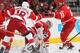 RALEIGH, NC - OCTOBER 04: Cam Ward #30 of the Carolina Hurricanes covers up the puck as teammate Jay Harrison #44 battles with Joakim Andersson #18 of the Detroit Red Wings during an NHL game on October 4, 2013 in the home opener at PNC Arena in Raleigh, North Carolina. (Photo by Gregg Forwerck/NHLI via Getty Images)