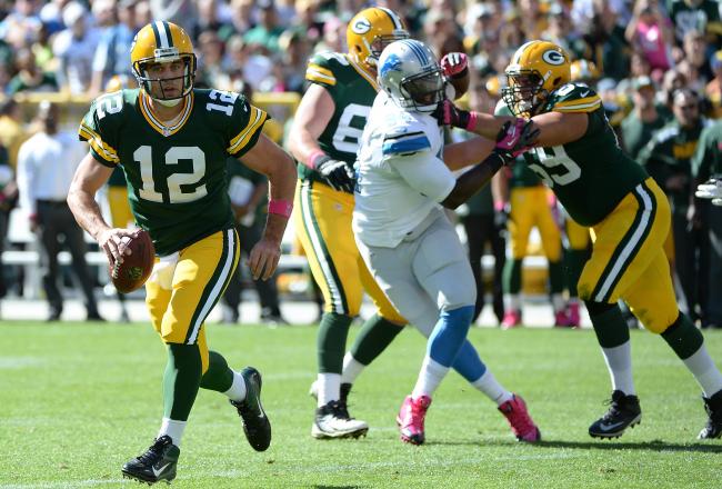 Hi-res-183674297-aaron-rodgers-of-the-green-bay-packers-rolls-out-of-the_crop_north