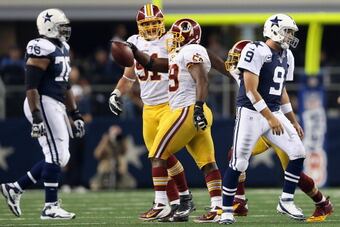 156838060-tony-romo-of-the-dallas-cowboys-walks-off-the-field_crop_north