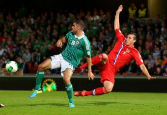 176514512-artem-dzyuba-of-russia-is-tackled-by-aaron-hughes-of_crop_north