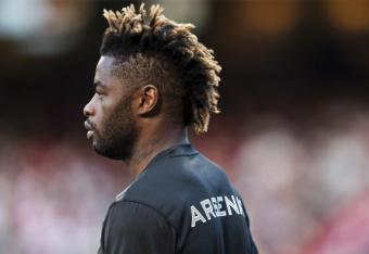 149473446-alex-song-of-arsenal-fc-looks-on-during-the-pre-season_crop_north