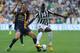 TURIN, ITALY - SEPTEMBER 22: Paul Pogba (R) of Juventus is tackled by Romulo Souza of Verona FC during the Serie A match between Juventus and Hellas Verona FC at Juventus Arena on September 22, 2013 in Turin, Italy. (Photo by Valerio Pennicino/Getty Images)