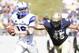 Oct 5, 2013; Annapolis, MD, USA; Air Force Falcons quarterback Karson Roberts (16) scrambles under pressure from Navy Midshipmen defensive end Paul Quessenberry (45) during the second half at Navy Marine Corps Memorial Stadium. Mandatory Credit: Paul Frederiksen-USA TODAY Sports