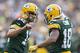 GREEN BAY, WI - SEPTEMBER 15: Aaron Rodgers #12 and Randall Cobb #18 of the Green Bay Packers celebrate after a touchdown against the Washington Redskins at Lambeau Field on September 15, 2013 in Green Bay, Wisconsin. The Packers defeated the Redskins 38-20. (Photo by Wesley Hitt/Getty Images)