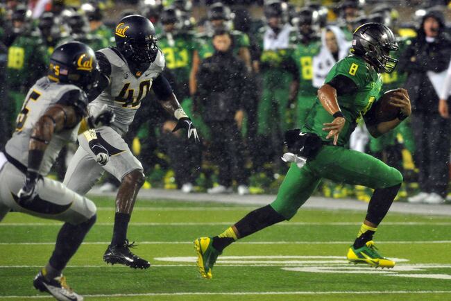 Hi-res-182264075-quarterback-marcus-mariota-of-the-oregon-ducks-runs_crop_north