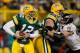 GREEN BAY, WI - DECEMBER 07: Paul Kruger #99 of the Baltimore Ravens grabs the jersey of Aaron Rodgers #12 of the Green Bay Packers as Chad Clifton #76 tries to block at Lambeau Field on December 7, 2009 in Green Bay, Wisconsin. The Packers defeated the Ravens 27-17. (Photo by Jonathan Daniel/Getty Images)