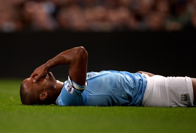 Hi-res-176927789-vincent-kompany-of-manchester-city-lies-injured-on-the_crop_north