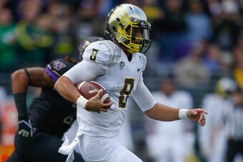 Hi-res-184234214-quarterback-marcus-mariota-of-the-oregon-ducks-rushes_crop_north