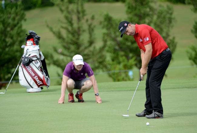 Hi-res-184409579-padraig-harrington-of-ireland-is-watched-by-his-caddie_crop_north