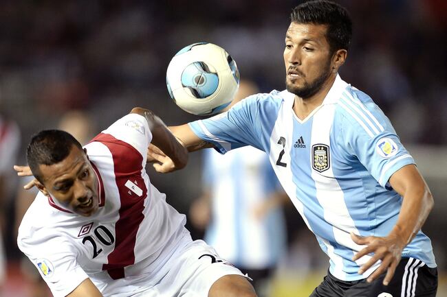 Hi-res-184185204-ezequiel-garay-of-argentina-vies-for-the-ball-with-luis_crop_north