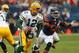 CHICAGO, IL - DECEMBER 16: Aaron Rodgers #12 of the Green Bay Packers rolls out to look for a receiver chased by Nick Roach #53 of the Chicago Bears at Soldier Field on December 16, 2012 in Chicago, Illinois. The Packers defeated the Bears 21-13. (Photo by Jonathan Daniel/Getty Images)