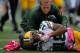 BALTIMORE, MD - OCTOBER 13: Randall Cobb #18 of the Green Bay Packers is attended to by a trainer after being injuired on a play in the second quarter during a game against the Baltimore Ravens at M&T Bank Stadium on October 13, 2013 in Baltimore, Maryland. (Photo by Patrick McDermott/Getty Images)