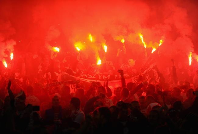 Hi-res-184769038-poland-fans-light-flares-prior-to-the-fifa-2014-world_crop_north