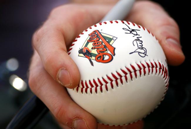 Hi-res-56998001-baltimore-orioles-fan-holds-onto-a-baseball-freshly_crop_north