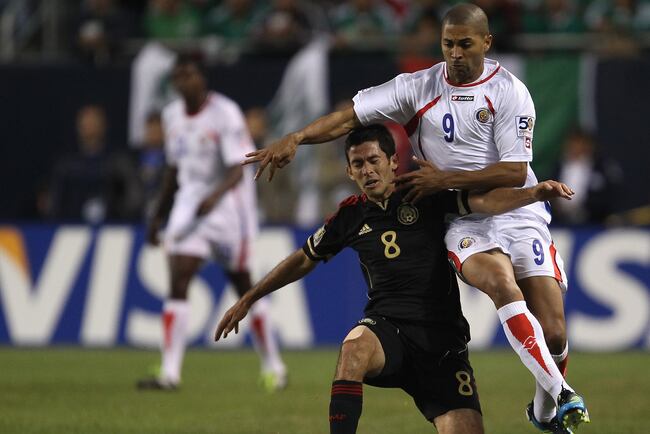 Hi-res-115952747-israel-castro-of-mexico-is-pushed-by-alvaro-saborio-of_crop_north