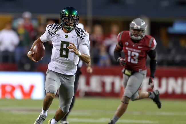 Hi-res-153206796-quarterback-marcus-mariota-of-the-oregon-ducks-rushes_crop_north