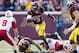 Oct 22, 2011; Minneapolis, MN, USA: Minnesota Gophers quarterback Marqueis Gray (5) runs for a first down against the Nebraska Cornhuskers in the fourth quarter at TCF Bank Stadium. The Cornhuskers won 41-14. Mandatory Credit: Jesse Johnson-USA TODAY Sports