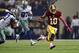Oct 13, 2013; Arlington, TX, USA; Washington Redskins quarterback Robert Griffin III (10) scrambles out of the pocket against the Dallas Cowboys in the second quarter at AT&T Stadium. Mandatory Credit: Tim Heitman-USA TODAY Sports