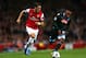 LONDON, ENGLAND - OCTOBER 01: Mesut Oezil of Arsenal goes past Camilo Zuniga of Napoli during UEFA Champions League Group F match between Arsenal FC and SSC Napoli at Emirates Stadium on October 1, 2013 in London, England. (Photo by Paul Gilham/Getty Images)
