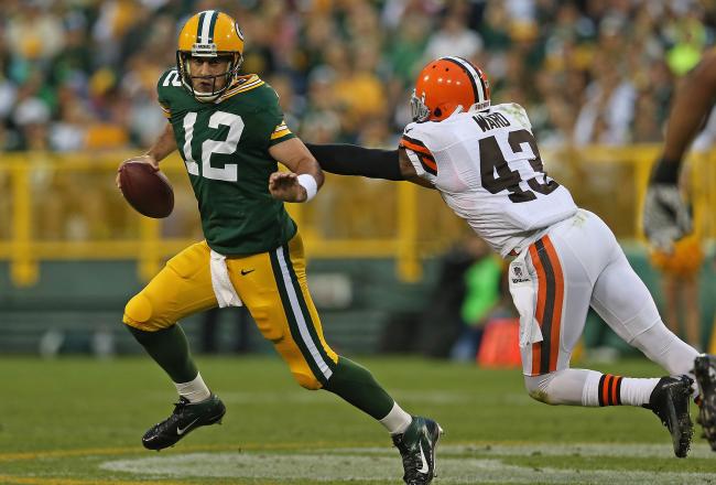 Hi-res-150454089-aaron-rodgers-of-the-green-bay-packers-rolls-out-past-t_crop_north