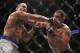 Oct 19, 2013; Houston, TX, USA; Cain Velasquez (red gloves) fights against Junior Dos Santos (blue gloves) in the world heavyweight championship bout during UFC 166 at Toyota Center. Mandatory Credit: Andrew Richardson-USA TODAY Sports