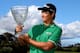 PERTH, AUSTRALIA - OCTOBER 20: (EDITORS NOTE: A polarizing filter was used for this image.) Jin Jeong of Korea holds aloft the winners trophy after defeating Ross Fisher of England on a play-off hole to win the tournament during day four of the Perth International at Lake Karrinyup Country Club on October 20, 2013 in Perth, Australia. (Photo by Paul Kane/Getty Images)