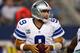 ARLINGTON, TX - OCTOBER 13: Tony Romo #9 of the Dallas Cowboys looks for an open receiver against the Washington Redskins at AT&T Stadium on October 13, 2013 in Arlington, Texas. (Photo by Tom Pennington/Getty Images)