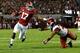 TUSCALOOSA, AL - OCTOBER 19: Kenyan Drake #17 of the Alabama Crimson Tide stiff arms Alan Turner #27 of the Arkansas Razorbacks on his way to a touchdown at Bryant-Denny Stadium on October 19, 2013 in Tuscaloosa, Alabama. (Photo by Kevin C. Cox/Getty Images)
