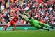 LIVERPOOL, ENGLAND - AUGUST 17: Philippe Coutinho of Liverpool shoots past Asmir Begovic of Stoke City during the Barclays Premier League match between Liverpool and Stoke City at Anfield on August 17, 2013 in Liverpool, England. (Photo by Clive Brunskill/Getty Images)