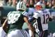 Oct 20, 2013; East Rutherford, NJ, USA; New England Patriots quarterback Tom Brady (12) looks to pass while under pressure from New York Jets defensive end Quinton Coples (98) during the first half at MetLife Stadium. Mandatory Credit: Ed Mulholland-USA TODAY Sports