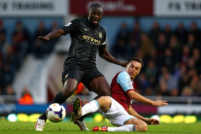 Hi-res-185351034-yaya-toure-of-manchester-city-is-tackled-by-mark-noble_crop_north