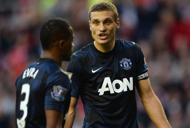 Hi-res-183160841-nemanja-vidic-of-manchester-united-gestures-to-patrice_crop_north
