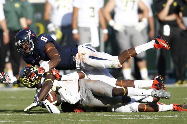 Hi-res-179978005-deanthony-thomas-of-the-oregon-ducks-gets-tackled-by_crop_north