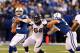 Oct 20, 2013; Indianapolis, IN, USA; Indianapolis Colts quarterback Andrew Luck (12) is pressured by Denver Broncos outside linebacker Von Miller (58) during the first half at Lucas Oil Stadium. Mandatory Credit: Brian Spurlock-USA TODAY Sports