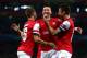 LONDON, ENGLAND - OCTOBER 01: Mesut Oezil (C)of Arsenal is congratulated by teammates Aaron Ramsey (L) and Olivier Giroud (R) after scoring the opening goal during UEFA Champions League Group F match between Arsenal FC and SSC Napoli at Emirates Stadium on October 1, 2013 in London, England. (Photo by Paul Gilham/Getty Images)
