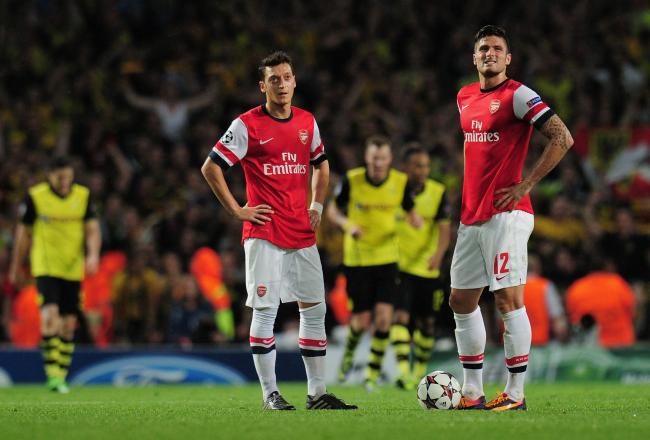 Hi-res-185587782-mesut-ozil-and-olivier-giroud-of-arsenal-react-after_crop_north