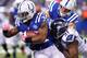 INDIANAPOLIS, IN - OCTOBER 06: Trent Richardson #34 of the Indianapolis Colts runs the ball as Chris Clemons #91 of the Seattle Seahawks wraps him up for a tackle from behind at Lucas Oil Stadium on October 6, 2013 in Indianapolis, Indiana. (Photo by Michael Hickey/Getty Images)