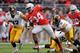 COLUMBUS, OH - OCTOBER 19: Carlos Hyde #34 of the Ohio State Buckeyes spins away from defenders John Lowdermilk #37 of the Iowa Hawkeyes and Anthony Hitchens #31 of the Iowa Hawkeyes in the second quarter for a 17-yard gain at Ohio Stadium on October 19, 2013 in Columbus, Ohio. (Photo by Jamie Sabau/Getty Images)
