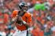 DENVER, CO - SEPTEMBER 29: Quarterback Peyton Manning #18 of the Denver Broncos rolls out of the pocket and looks for a receiver downfield against the Philadelphia Eagles at Sports Authority Field Field at Mile High on September 29, 2013 in Denver, Colorado. (Photo by Dustin Bradford/Getty Images)