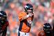Oct 13, 2013; Denver, CO, USA; Denver Broncos quarterback Peyton Manning (18) checks off above center Manny Ramirez (66) and offensive guard Justin Boren (65) in the third quarter against the Jacksonville Jaguars at Sports Authority Field at Mile High. The Broncos defeated the Jaguars 35-19. Mandatory Credit: Ron Chenoy-USA TODAY Sport