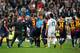 MADRID, SPAIN - MARCH 02: Referee Miguel Perez (C) pulls a red card for goalkeeper Victor Valdes (L) of Barcelona, held back by teammates, after the final whistle of the la Liga match between Real Madrid CF and FC Barcelona at Estadio Santiago Bernabeu on March 2, 2013 in Madrid, Spain. (Photo by Jasper Juinen/Getty Images)