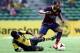 KUALA LUMPUR, MALAYSIA - AUGUST 10: Martin Montoya of Barcelona FC is tackled by S. Kunanalan of Malaysia during the friendly match between FC Barcelona and Malaysia at the Shah Alam Stadium on August 10, 2013 in Kuala Lumpur, Malaysia. (Photo by Stanley Chou/Getty Images)