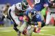 EAST RUTHERFORD, NJ - OCTOBER 06: Eli Manning #10 of the New York Giants is sacked by Bennie Logan #96 of the Philadelphia Eagles in the fourth quarter at MetLife Stadium on October 6, 2013 in East Rutherford, New Jersey. The Eagles defeat the Giants 36-21. (Photo by Maddie Meyer/Getty Images)