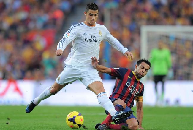 Hi-res-185937588-cristiano-ronaldo-of-real-madrid-cf-is-tackled-by-xavi_crop_north