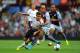 BIRMINGHAM, ENGLAND - AUGUST 24: Liverpool player Phillipe Coutinho (l) is challenged by Karim El Ahmadi during the Barclays Premier League match between Aston Villa and Liverpool at Villa Park on August 24, 2013 in Birmingham, England. (Photo by Stu Forster/Getty Images)