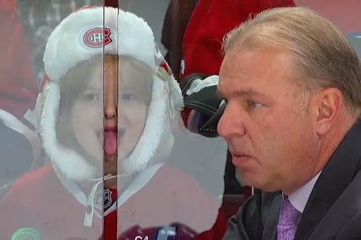 Young Girl Sticks Tongue in Between Glass During NHL Game