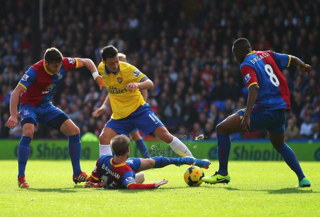 Hi-res-185914111-mesut-oezil-of-arsenal-is-challenged-by-barry-bannan_crop_north